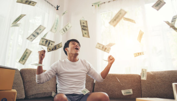 Happy man with cash dollars flying in home office, Rich from bus